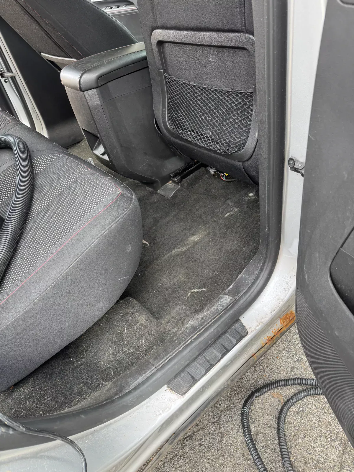 Rear floor carpet of a car being vacuumed by Buffalo Carpet NY