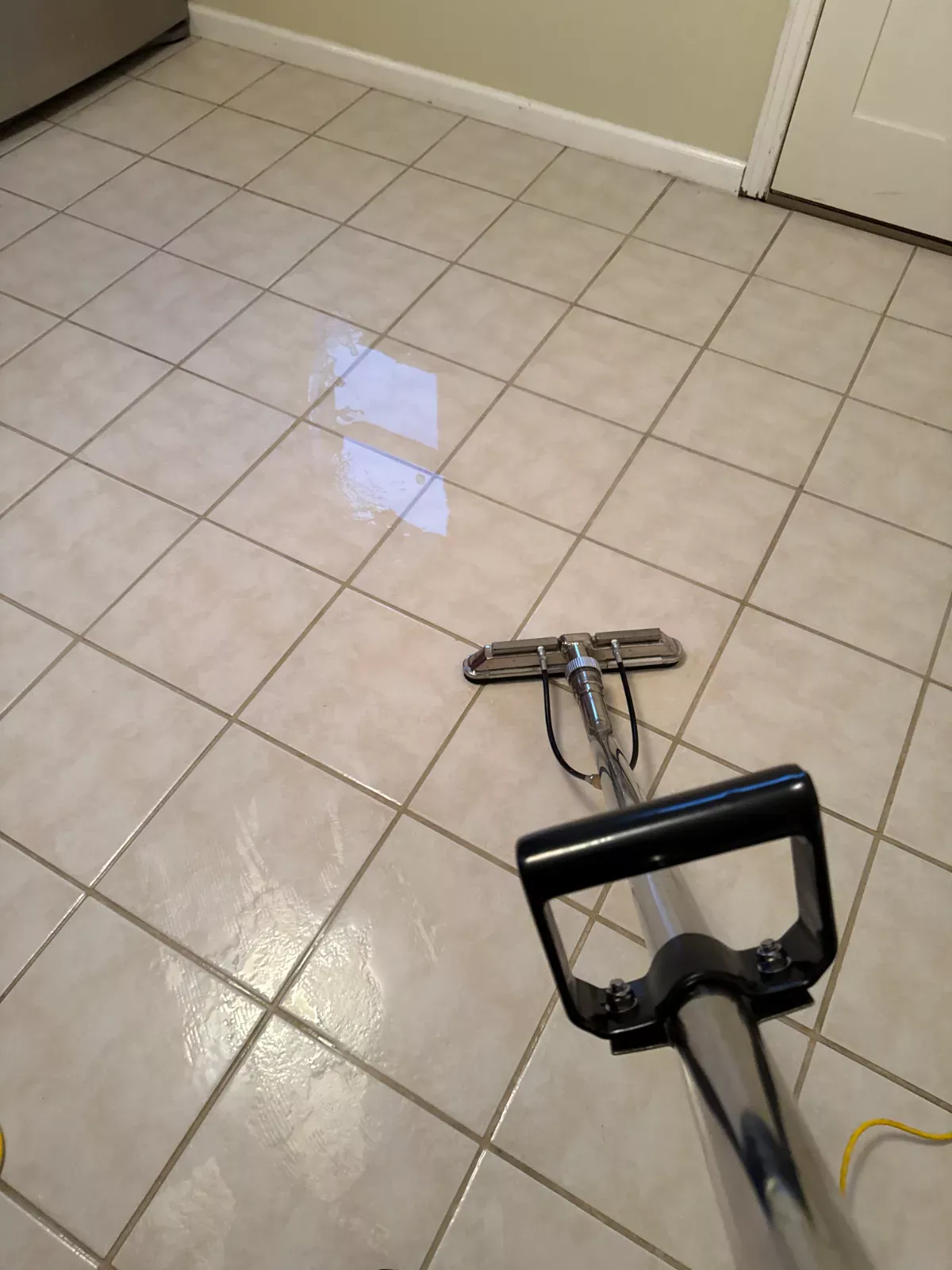 Ceramic tile floor being cleaned with a professional hard surface tool by Buffalo Carpet NY