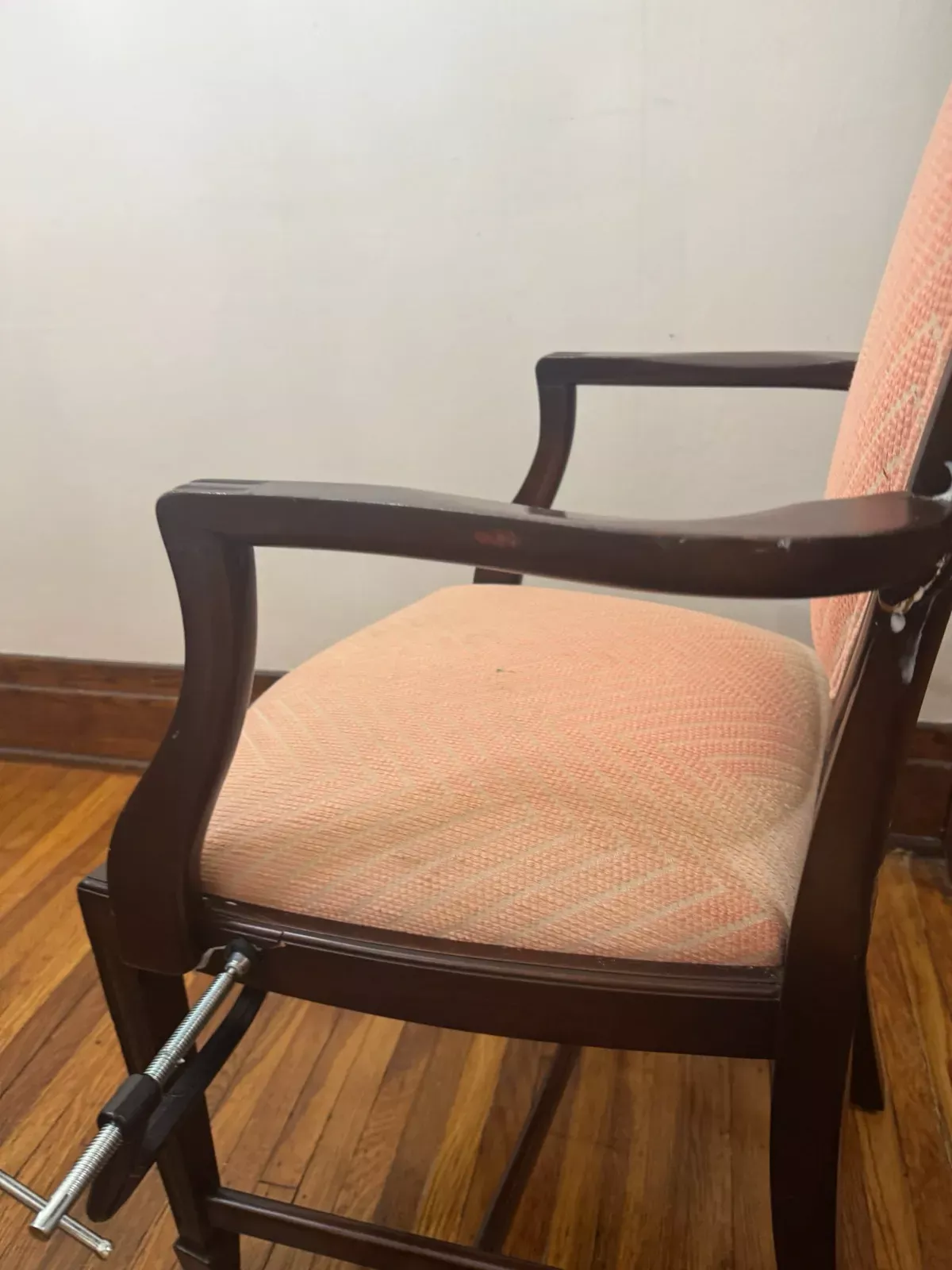 Upholstered armchair with coral fabric seat cleaned by Buffalo Carpet NY